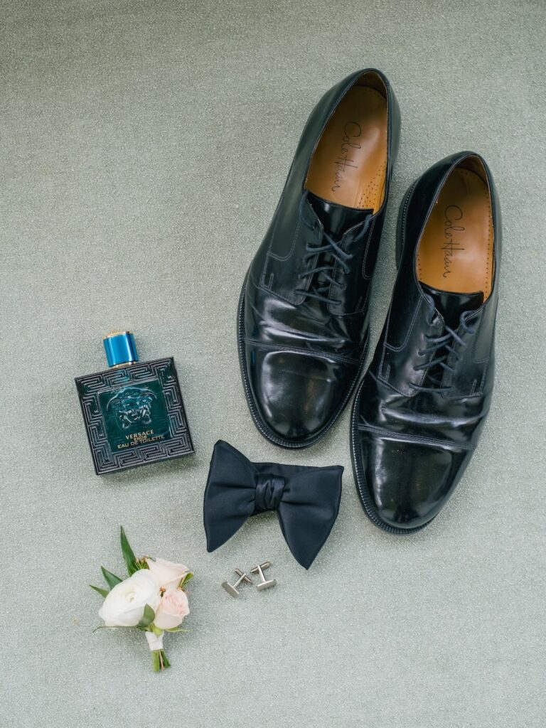 Groom details flatlay with dusty pink & greens.