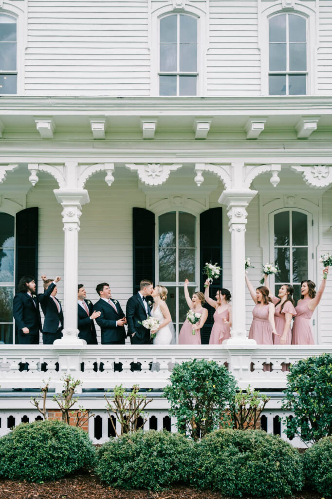 Wedding party cheering on the Merrimon-Wynne House porch.