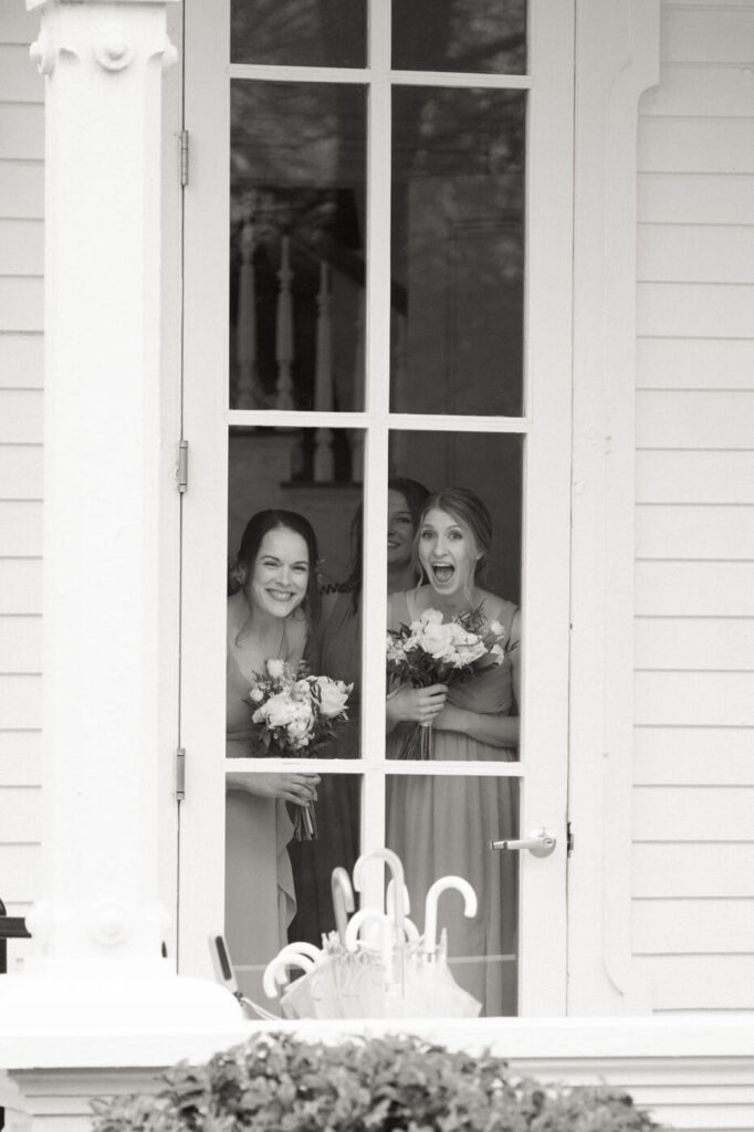 Bridesmaids waiting for their ceremony entrance into the Merrimon-Wynne Carriage House.