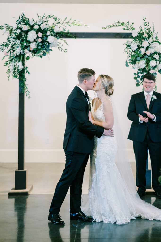 First kiss after ceremony at the Carriage house at Merrimon-Wynne House