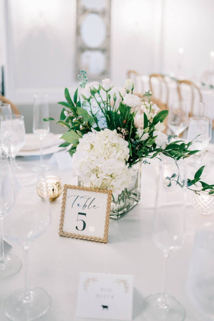 Lush table florals by English Garden adorning the reception space in the carriage house.