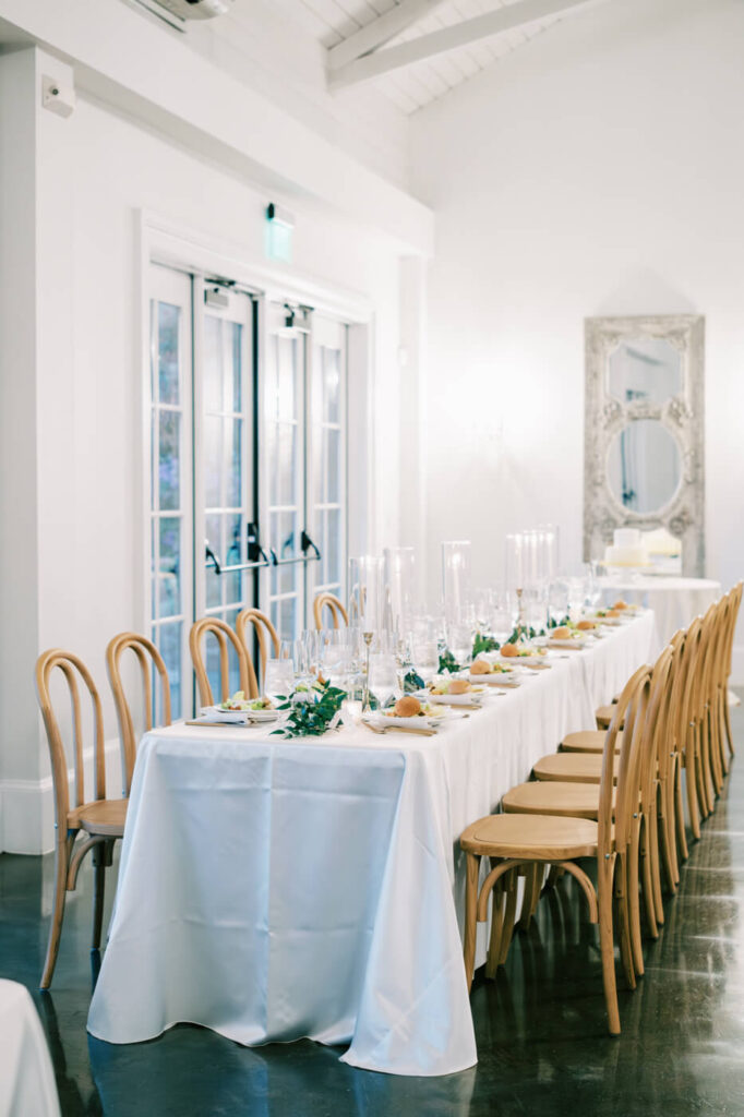 full tablescape and Lush table florals by English Garden adorning the reception space in the carriage house.