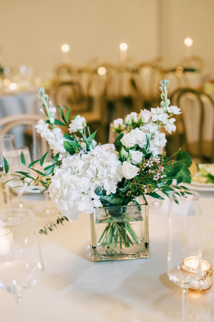 Lush table florals by English Garden adorning the reception space in the carriage house.