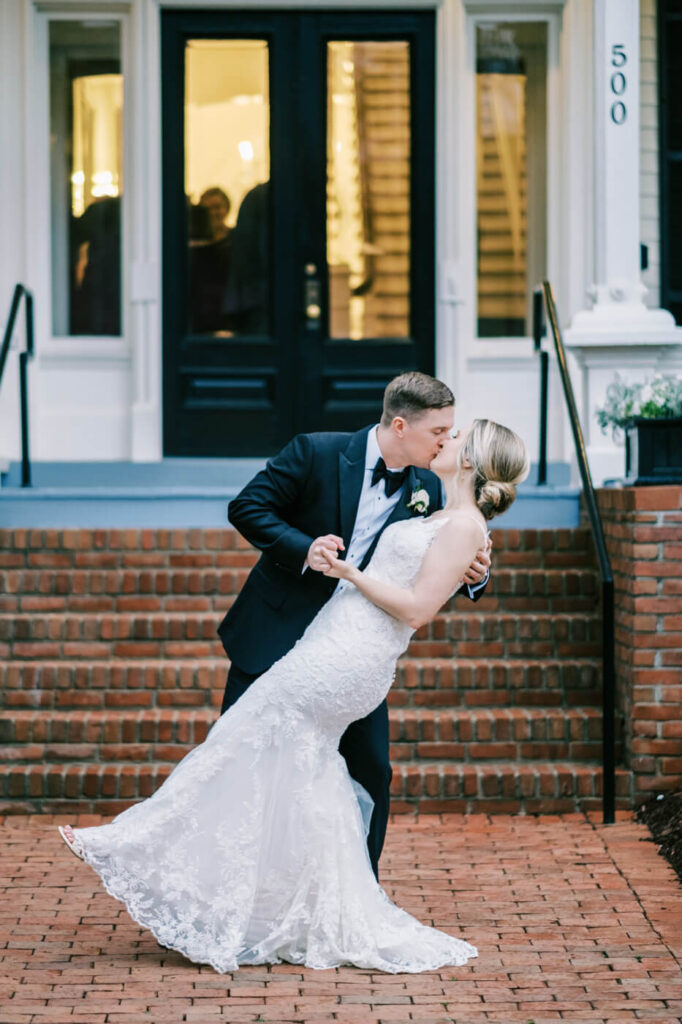 Bride & Groom kiss in front of Merrimon-Wynne House.