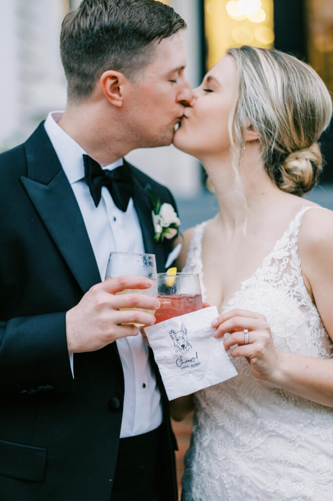 Bride & Groom cocktail hour kiss in front of Merrimon-Wynne House.