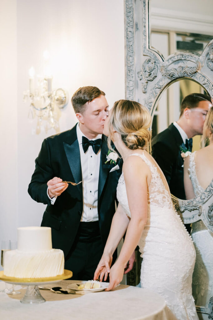 Bride & groom cut a Simple white Publix wedding cake in the carriage house.