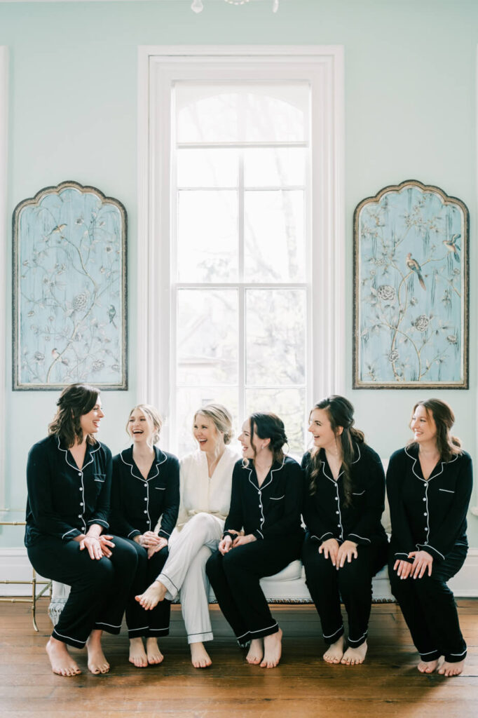 Bride & bridesmaids in matching outfits while getting ready at the Merrimon-Wynne House in Raleigh, NC.