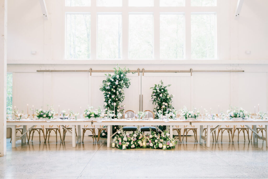 Beautiful sweetheart table adorned with lush greenery and floral arrangements at Carolina Grove