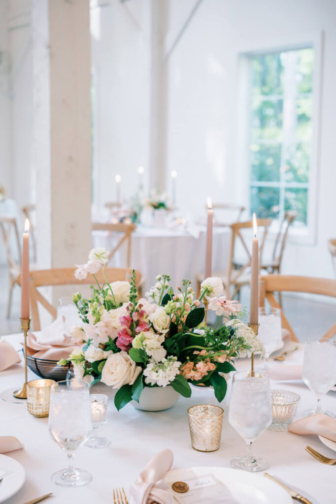 Elegant reception space with warm candlelight and floral centerpieces at Carolina Grove