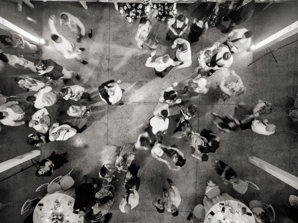 Black and white overhead shot of the dance floor – A creative, artistic shot capturing the movement of wedding guests dancing from above.