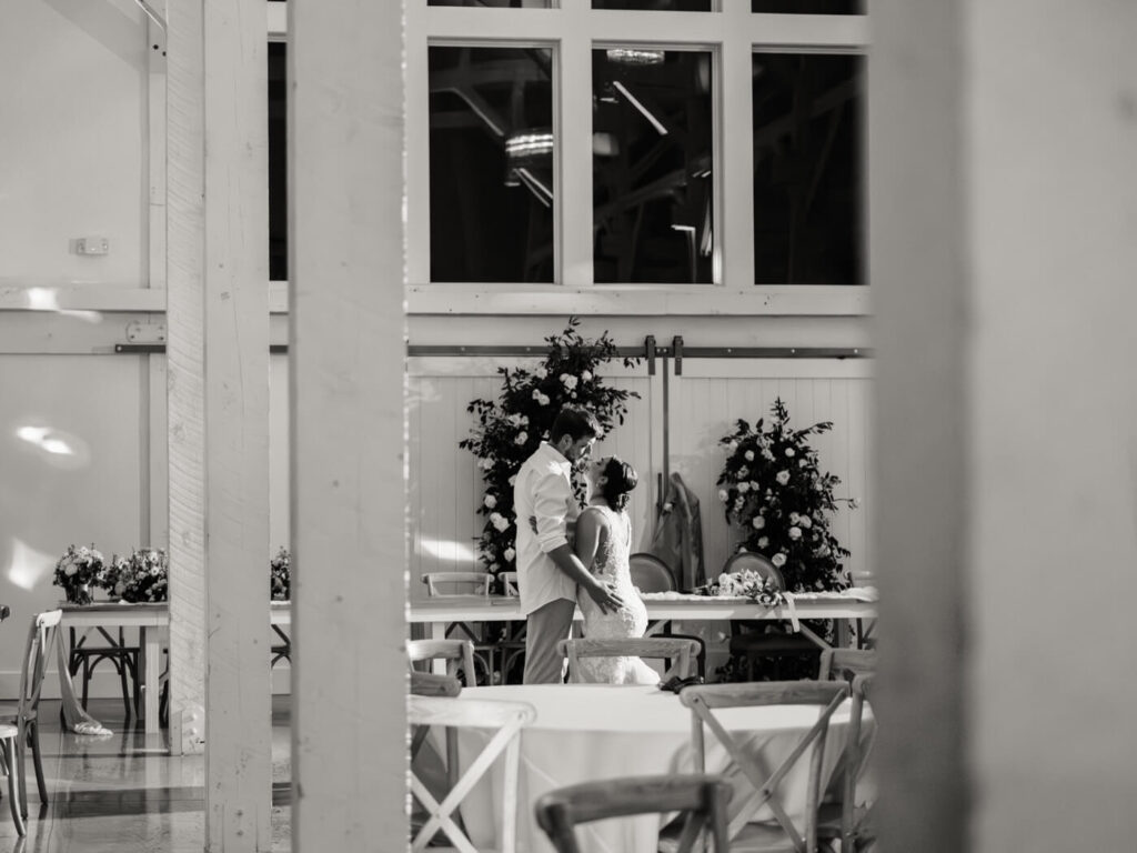 A private moment between the bride and groom – A romantic black-and-white image capturing a quiet moment between the couple at their reception.