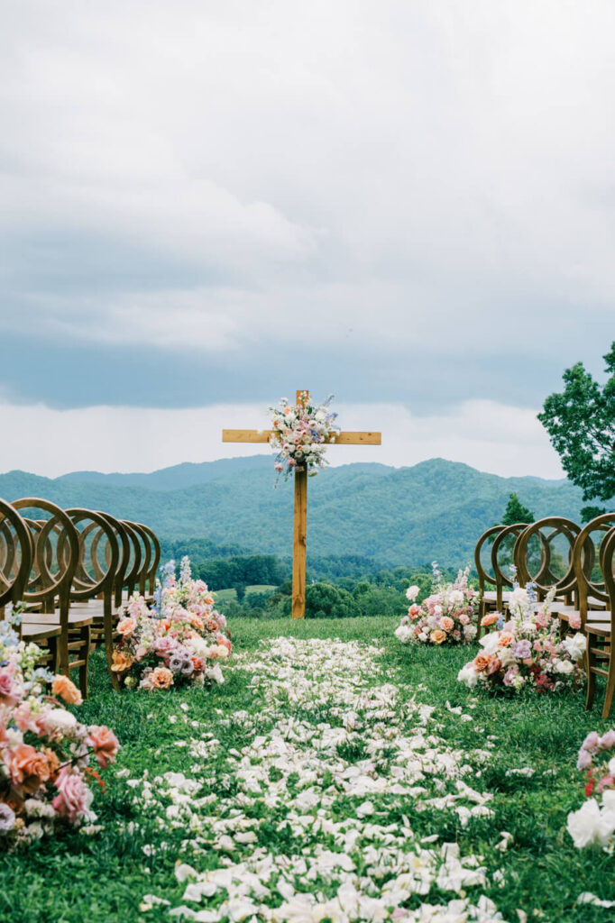 Ceremony aisle lined with flowers and petal path, part of an Asheville mountain wedding captured by The Reeses.