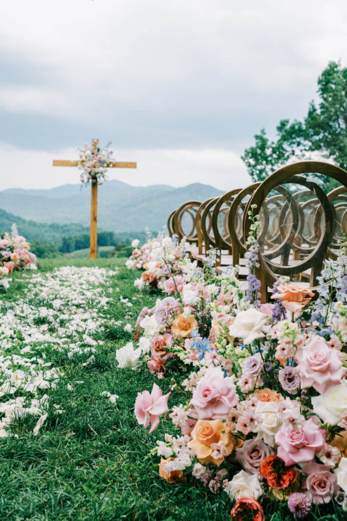 Ceremony aisle with petal path and floral decor, part of an Asheville mountain wedding by The Reeses.