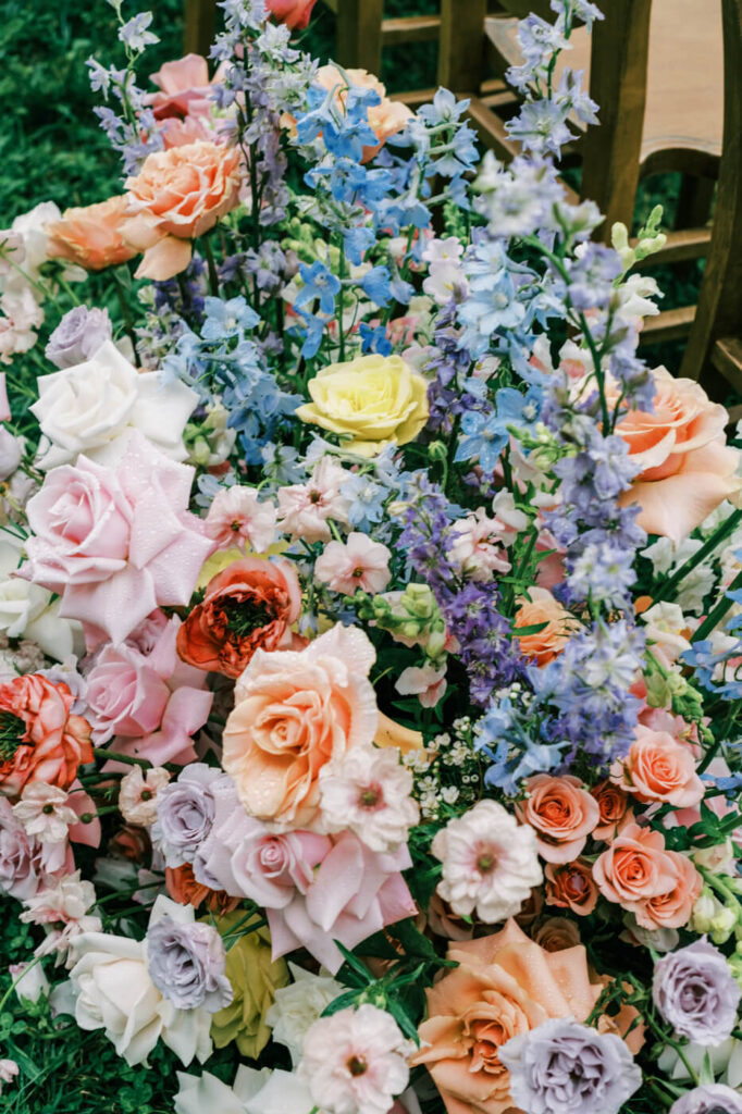 Close-up of floral arrangement along the aisle, featured in an Asheville mountain wedding by The Reeses