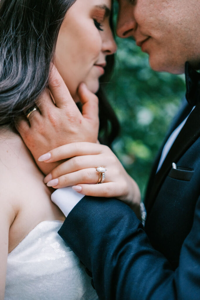 Close-up of the bride and groom’s hands intertwined, highlighting their wedding rings and the timeless romance of their Greensboro wedding.