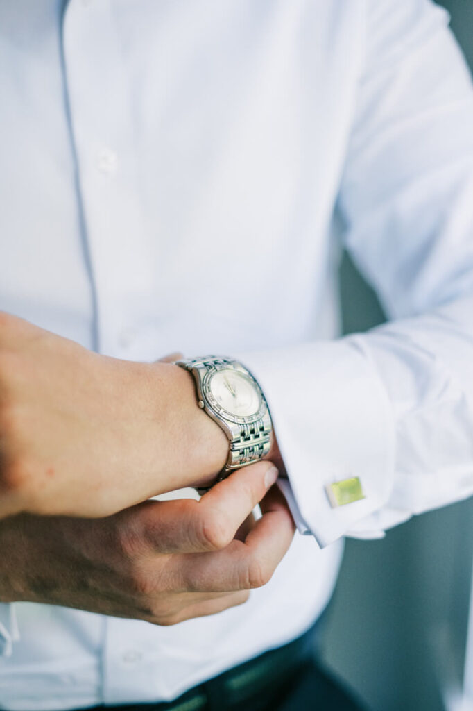 Timeless Groom’s Watch and Cufflinks – A close-up of the groom’s wristwatch and monogrammed cufflinks, adding a touch of classic elegance.