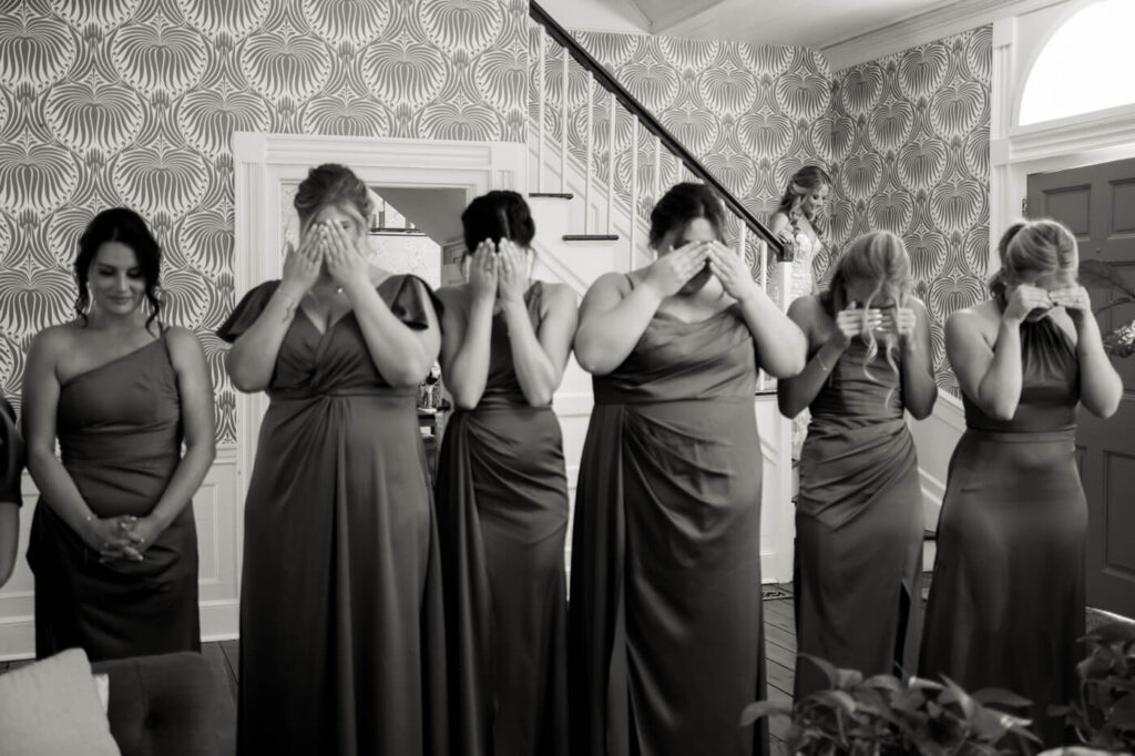 Bridesmaids covering their eyes, waiting for the big reveal of the bride at Historic Robertson House.