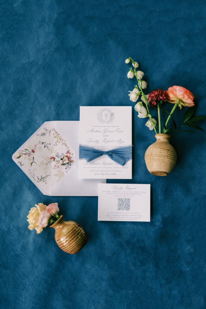 Flat lay of wedding invitations and florals for an elegant Historic Robertson House wedding in South Carolina.