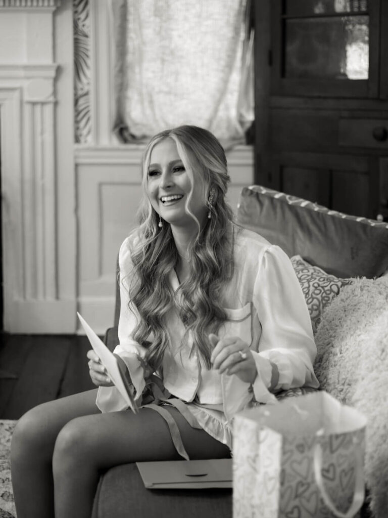 Bride's joyful reaction while reading a letter from the groom on the morning of their wedding at Historic Robertson House.