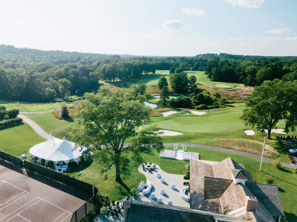 Aerial view of New York Country Club wedding setup including ceremony space, cocktail hour patio, and reception tent